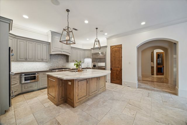 a kitchen with stainless steel appliances granite countertop a stove and a refrigerator