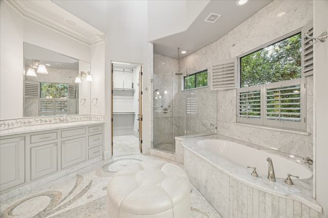 a spacious bathroom with a tub sink and mirror