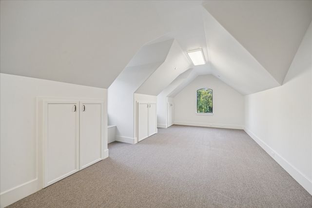 a utility room with stainless steel appliances white cabinets and a sink