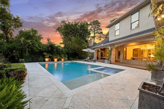 a view of house with swimming pool outdoor seating