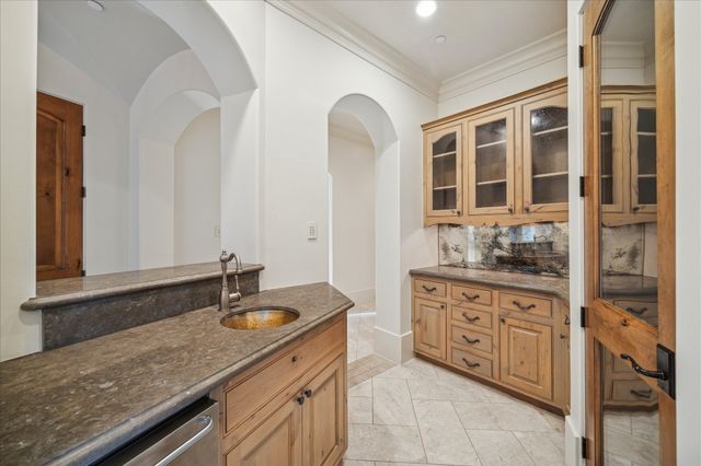 a bathroom with a granite countertop double vanity sink and mirror