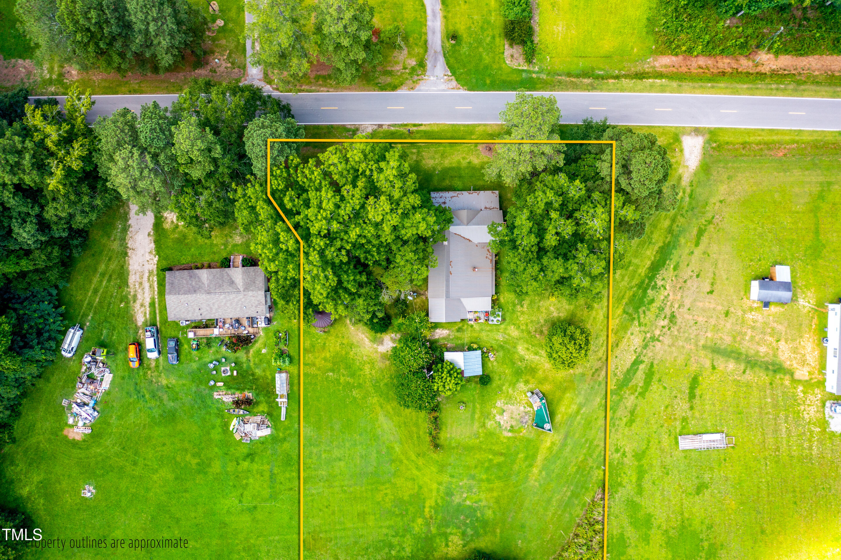 7167 Adolph Road Bailey, NC 27807 - Photo 6 of 18 a backyard of a house with lots of green space and garden