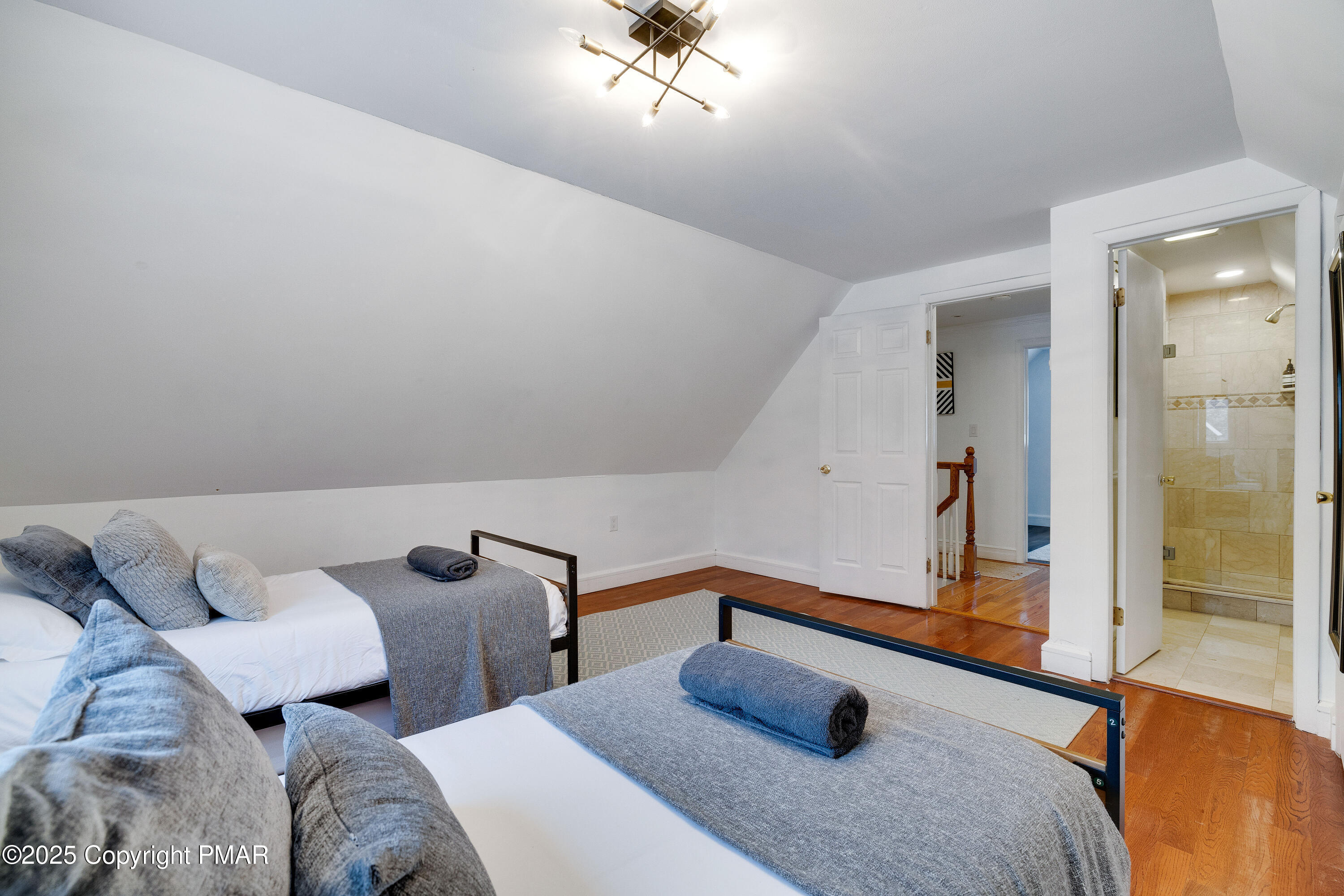 3137 Fern Road Pocono Summit, PA 18346 - Photo 24 of 51 a bedroom with a bed and a chandelier