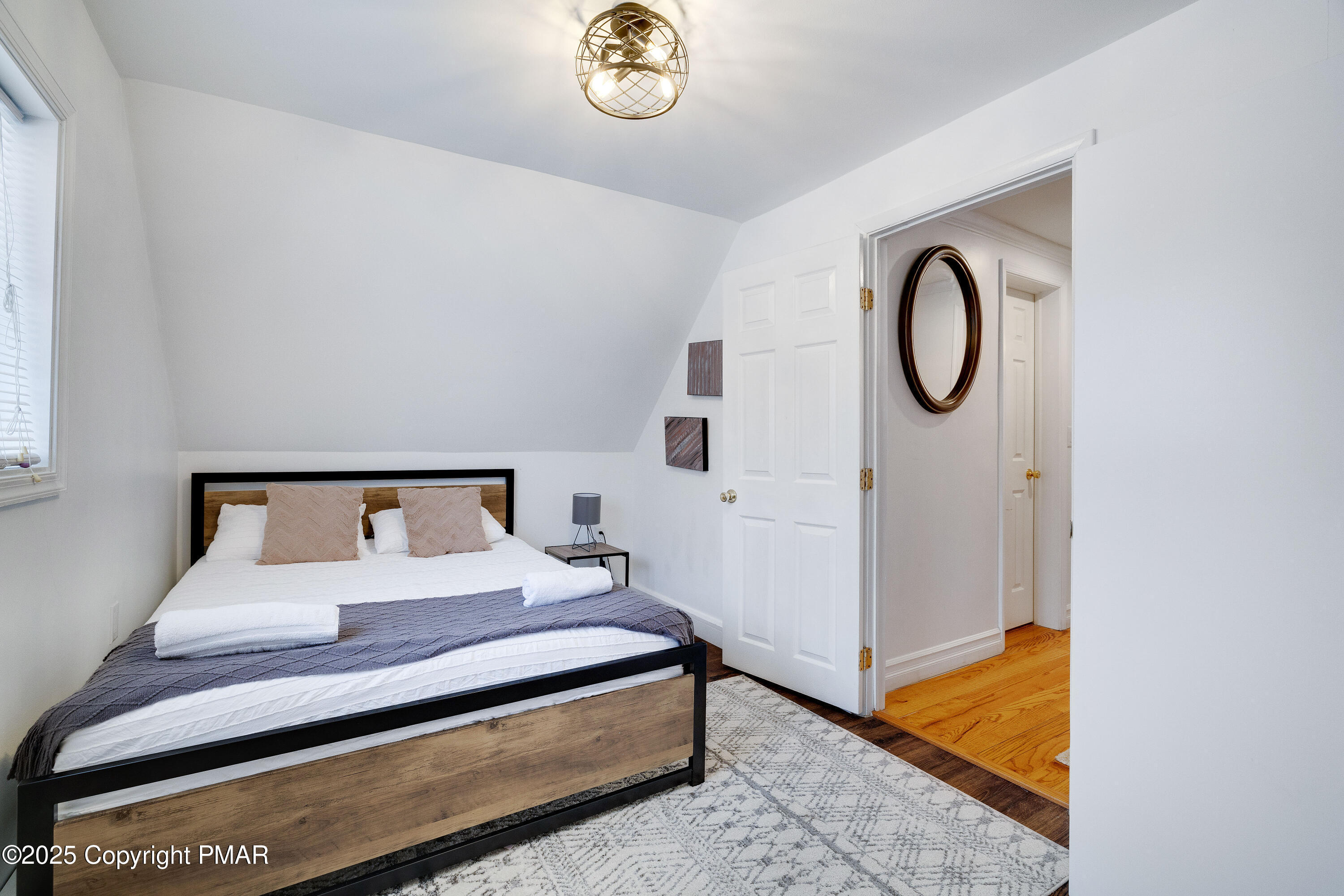 3137 Fern Road Pocono Summit, PA 18346 - Photo 25 of 51 a bedroom with a bed and a chandelier