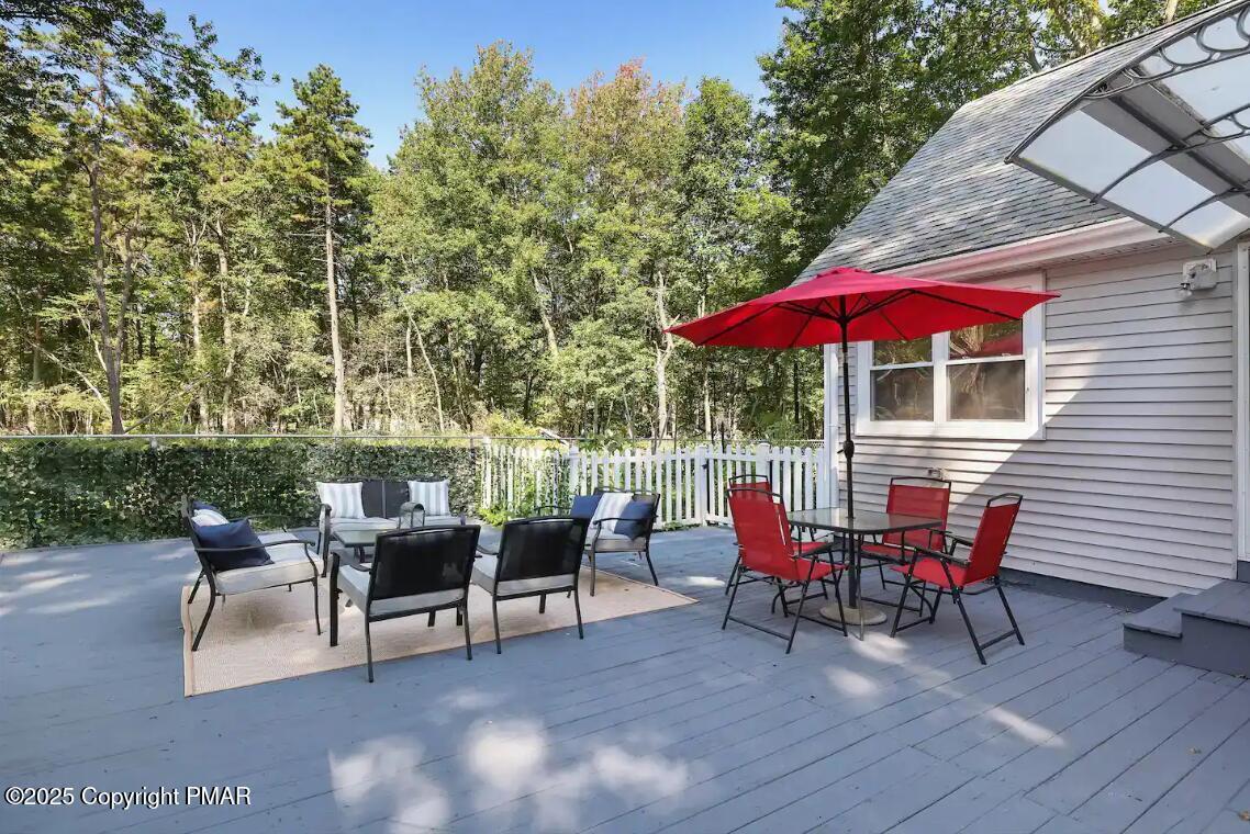 3137 Fern Road Pocono Summit, PA 18346 - Photo 3 of 51 a patio with tables and chairs
