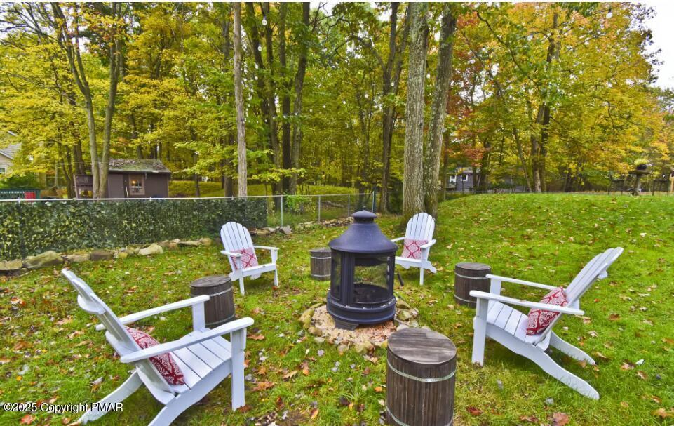 3137 Fern Road Pocono Summit, PA 18346 - Photo 37 of 51 a view of a chairs and table in backyard of the house