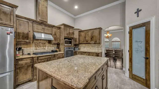 a kitchen with stainless steel appliances granite countertop a sink and cabinets