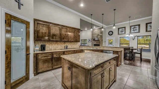 a kitchen with a stove a refrigerator a oven and a sink with wooden floor