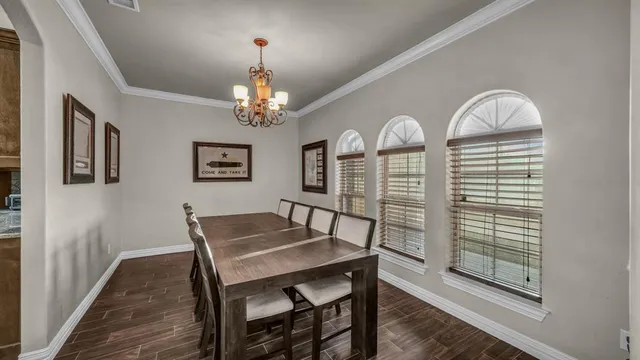 a view of a dining room with furniture and chandelier