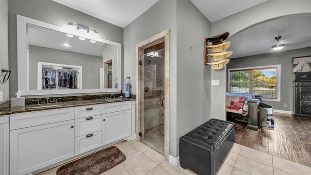 a bathroom with sinks mirror and a shower