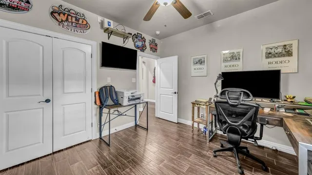 a view of a workspace with furniture and a flat screen tv