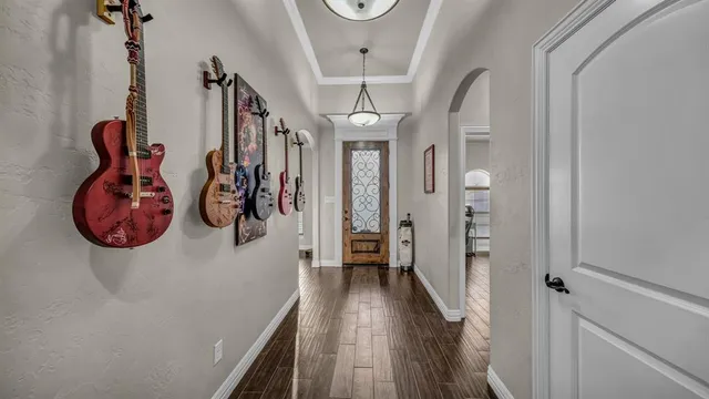 a view of a hallway with wooden floor and windows