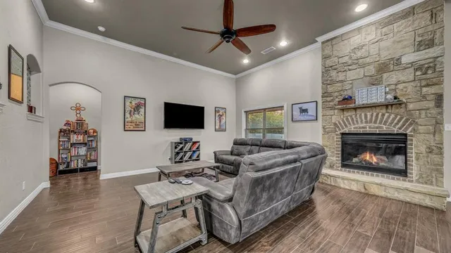 a living room with furniture a flat screen tv and a fireplace