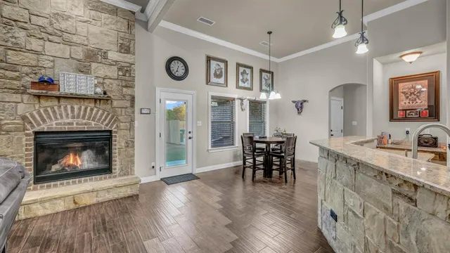 a open kitchen view with furniture a fireplace and wooden floor