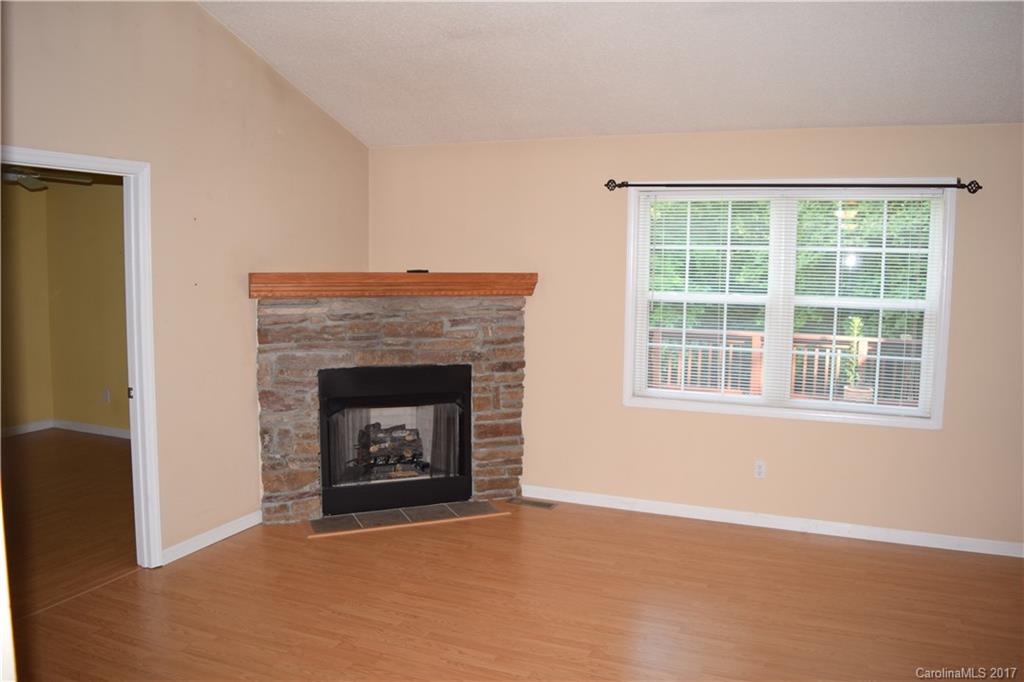 171 Observation Ridge Rutherfordton, NC 28139 - Photo 2 of 24 a living room with a fireplace and a window