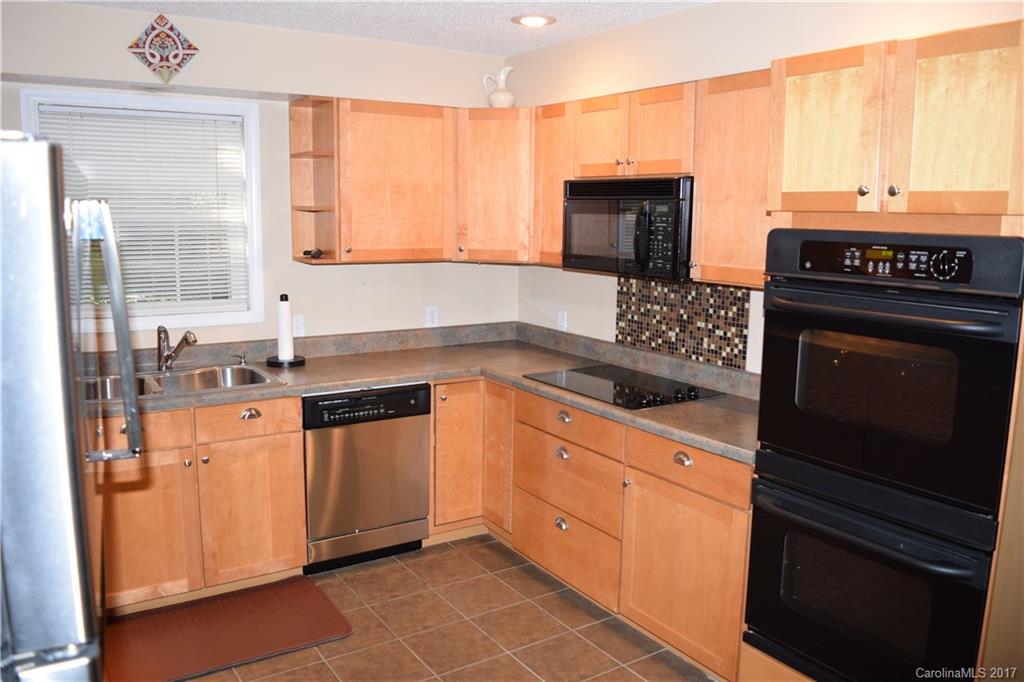171 Observation Ridge Rutherfordton, NC 28139 - Photo 17 of 24 a kitchen with granite countertop a stove sink and cabinets