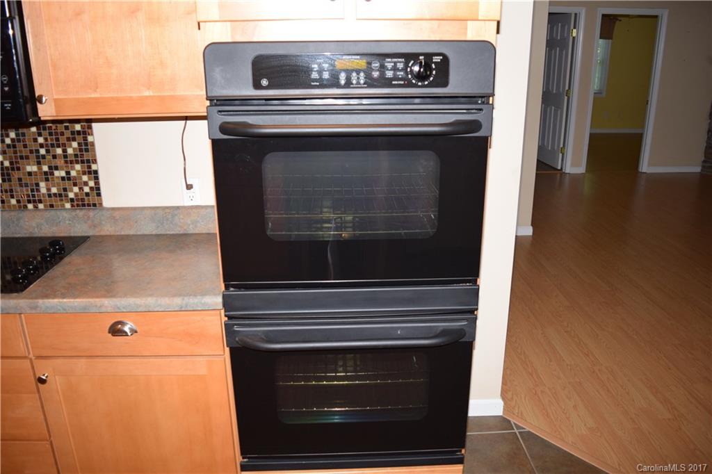 171 Observation Ridge Rutherfordton, NC 28139 - Photo 18 of 24 a stove top oven sitting inside of a kitchen