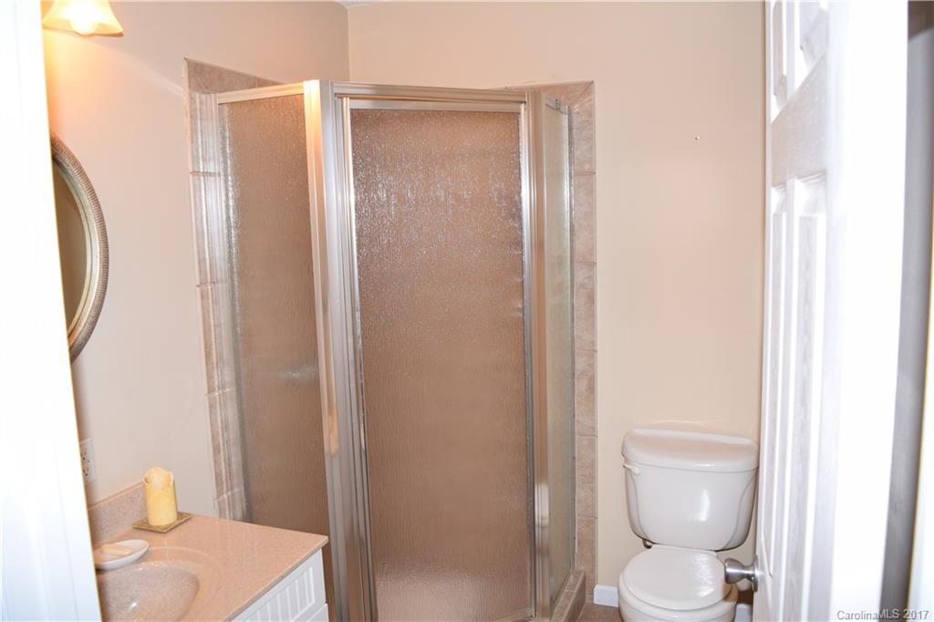 171 Observation Ridge Rutherfordton, NC 28139 - Photo 6 of 24 a white toilet sitting next to a bathroom sink