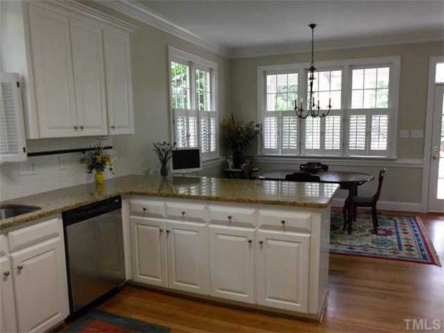 3100 Darien Drive Raleigh, NC 27607 - Photo 3 of 17 a kitchen with granite countertop white cabinets white appliances a sink and a window