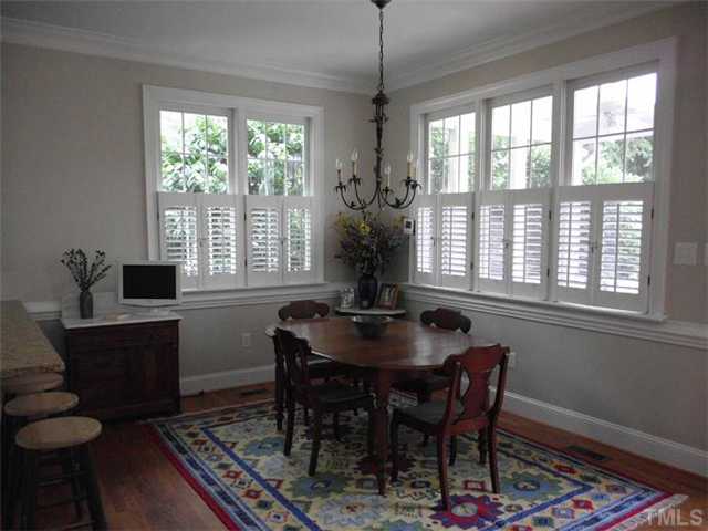 3100 Darien Drive Raleigh, NC 27607 - Photo 4 of 17 a dining room with furniture a chandelier and wooden floor