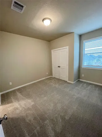 an empty room with a empty space and windows