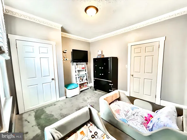 a bedroom with furniture and a wooden floor