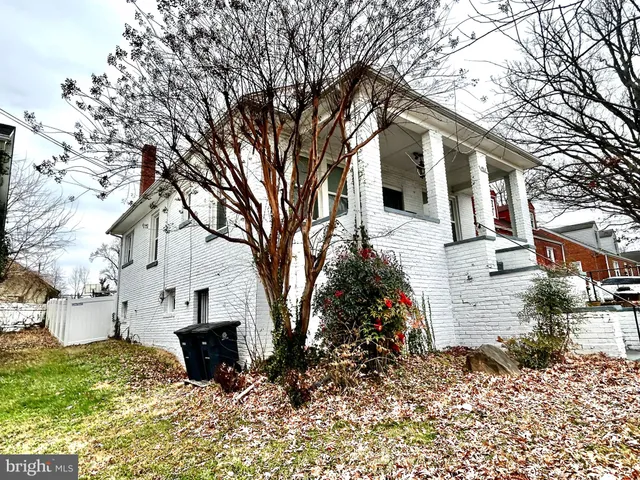 a front view of a house with a yard covered in snow
