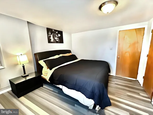 a bedroom with a bed and flat screen tv