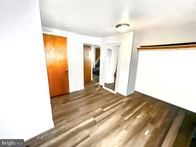 a view of a room with wooden floor and window