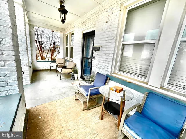 a living room filled with furniture and a window
