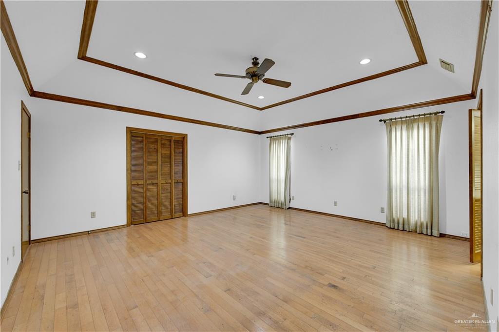 2016 South 5th Street, Unit 17 McAllen, TX 78503 - Photo 11 of 20 an empty room with wooden floor and windows