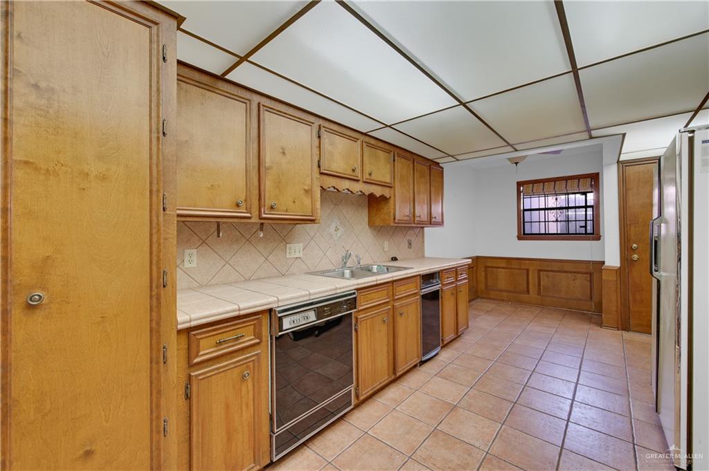 2016 South 5th Street, Unit 17 McAllen, TX 78503 - Photo 17 of 20 a kitchen with stainless steel appliances granite countertop a sink and cabinets