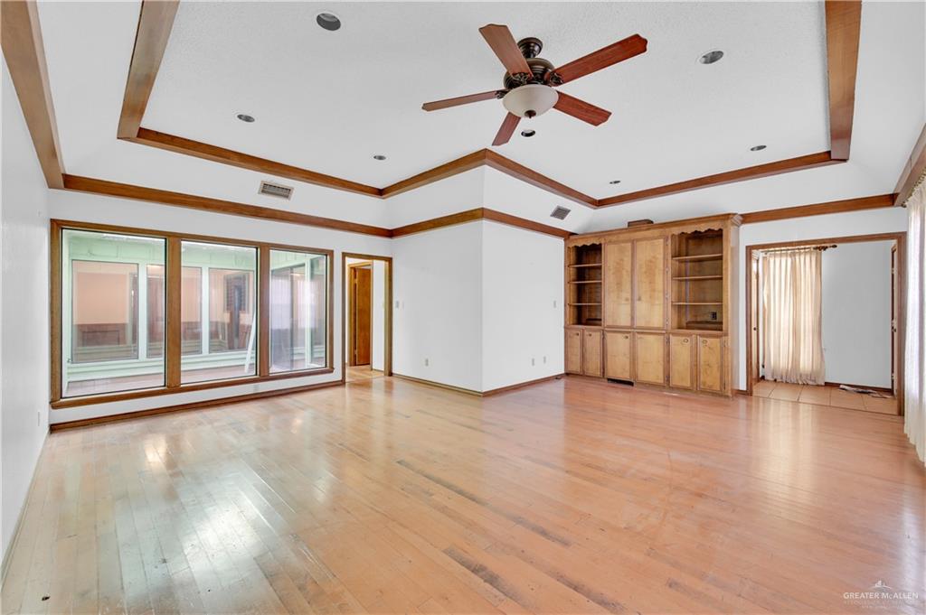 2016 South 5th Street, Unit 17 McAllen, TX 78503 - Photo 5 of 20 a view of n empty room with wooden floor and a ceiling fan