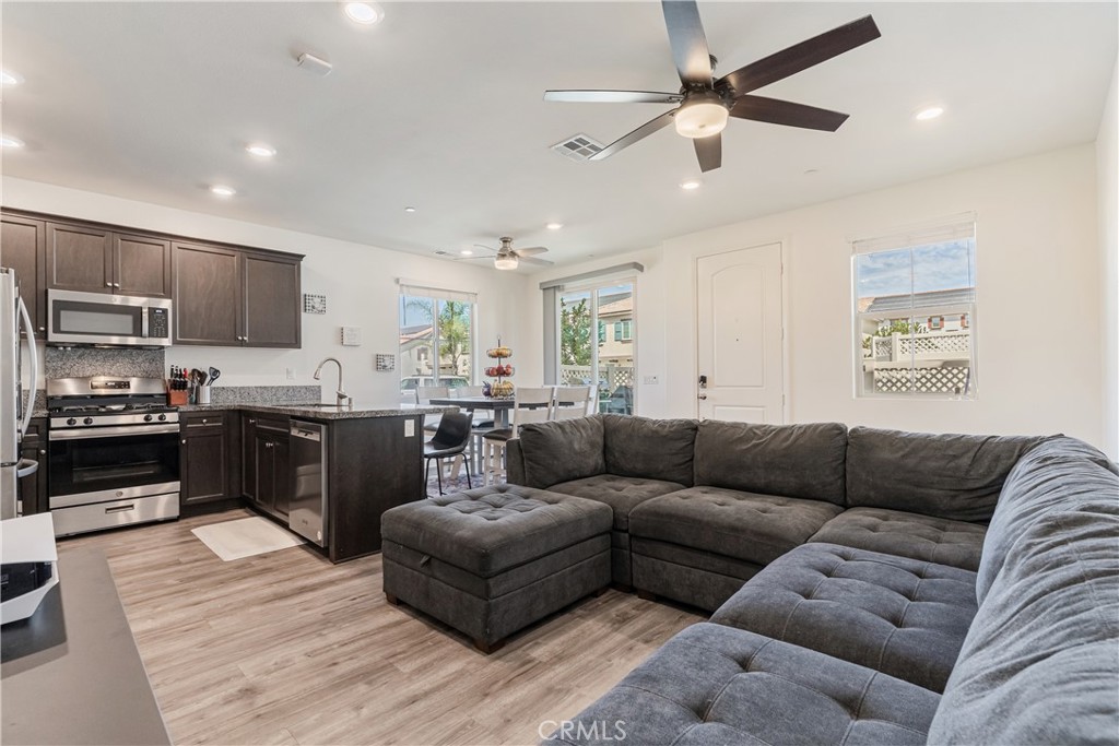 41973 Rondo Street, Unit 1203 Murrieta, CA 92562 - Photo 11 of 48 a living room with furniture kitchen and a wooden floor