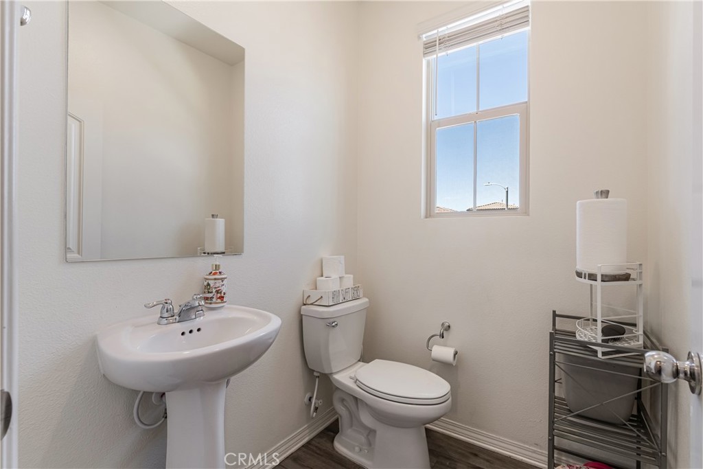 41973 Rondo Street, Unit 1203 Murrieta, CA 92562 - Photo 14 of 48 a bathroom with a sink toilet and a mirror
