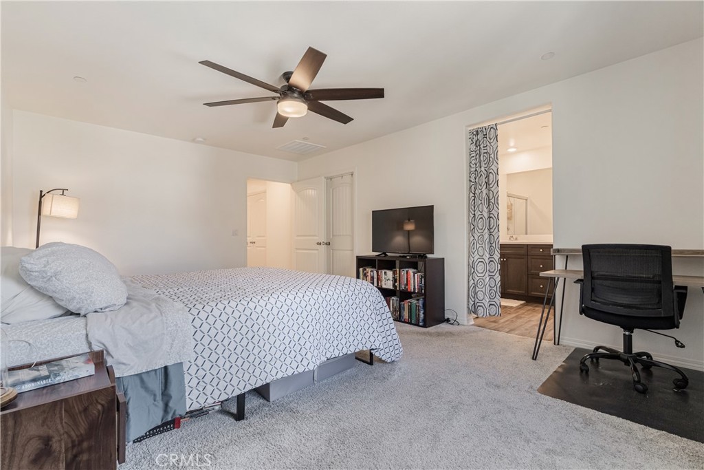 41973 Rondo Street, Unit 1203 Murrieta, CA 92562 - Photo 16 of 48 a bedroom with a bed and furniture