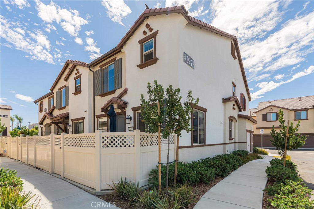 41973 Rondo Street, Unit 1203 Murrieta, CA 92562 - Photo 2 of 48 a front view of a house with a yard