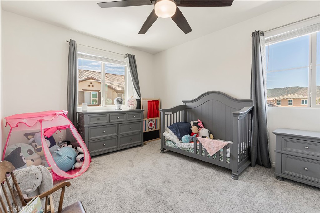 41973 Rondo Street, Unit 1203 Murrieta, CA 92562 - Photo 22 of 48 a bedroom with a bed and window