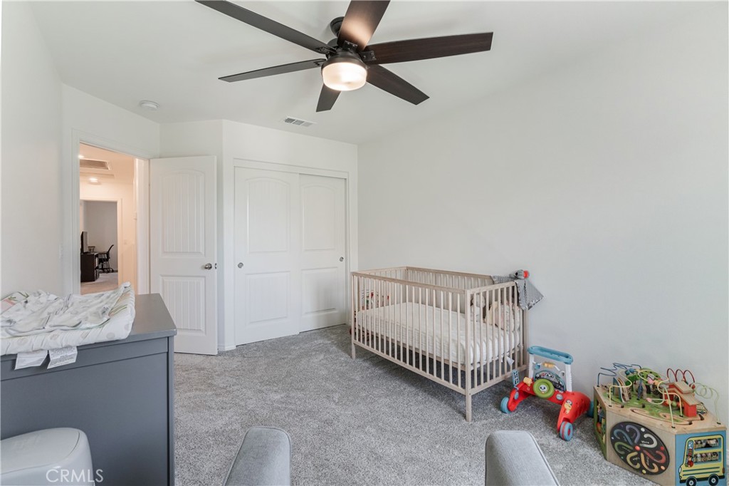 41973 Rondo Street, Unit 1203 Murrieta, CA 92562 - Photo 24 of 48 a bedroom with a bed and a chandelier