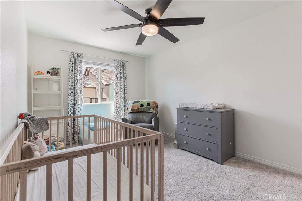 41973 Rondo Street, Unit 1203 Murrieta, CA 92562 - Photo 26 of 48 a view of a bedroom with furniture window and a ceiling fan
