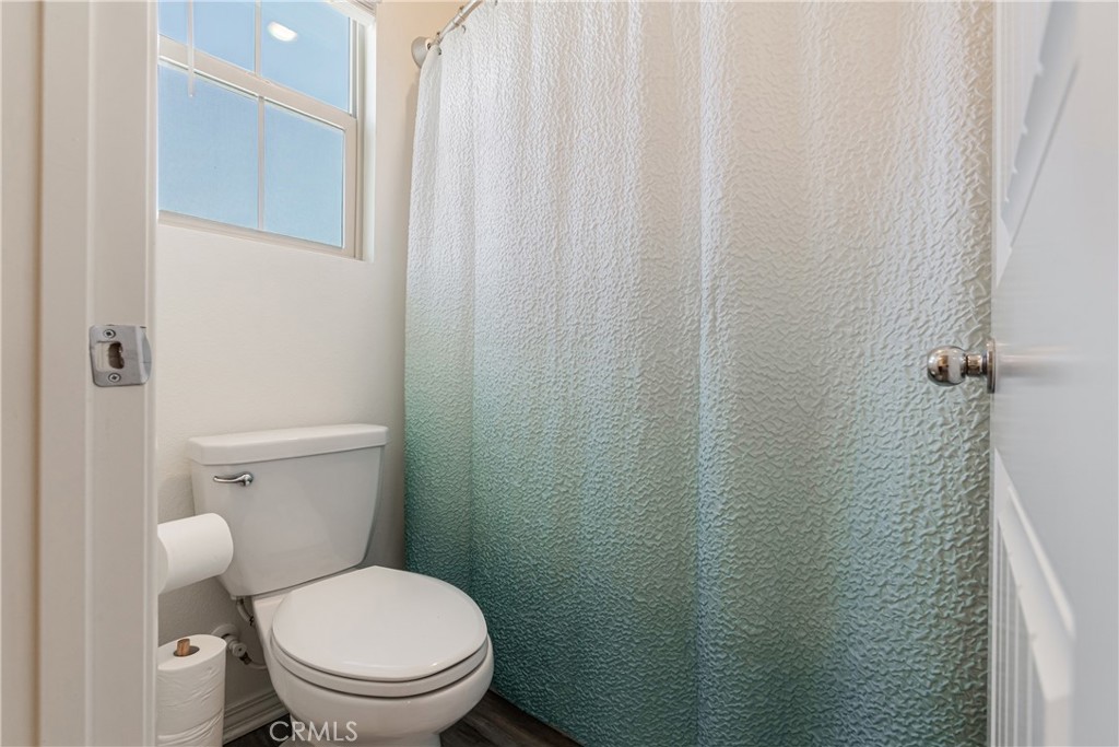 41973 Rondo Street, Unit 1203 Murrieta, CA 92562 - Photo 28 of 48 a white toilet sitting next to a shower curtain