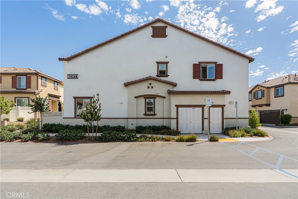 41973 Rondo Street, Unit 1203 Murrieta, CA 92562 - Photo 35 of 48 a front view of a house with a yard