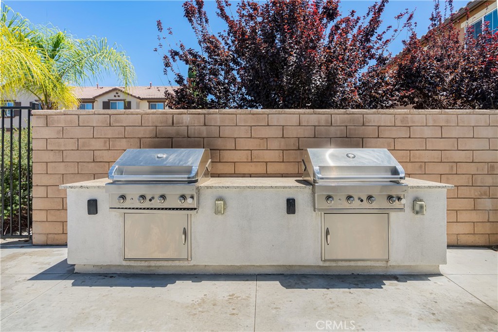 41973 Rondo Street, Unit 1203 Murrieta, CA 92562 - Photo 42 of 48 a kitchen with a stove and cabinets