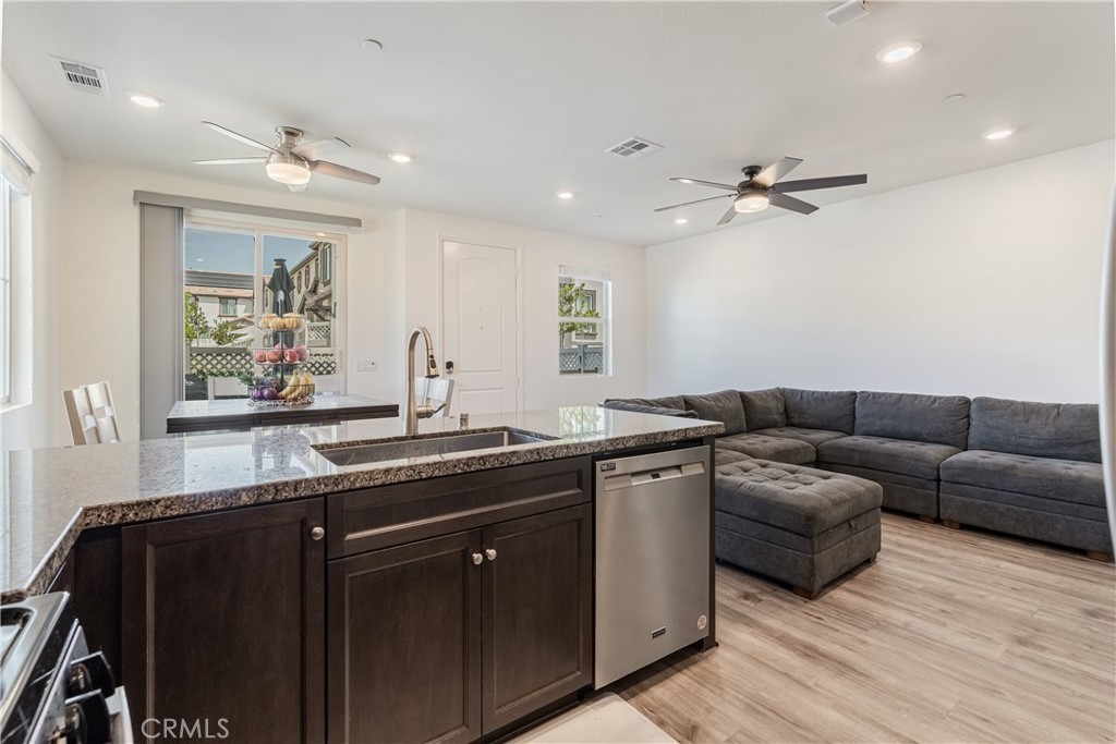 41973 Rondo Street, Unit 1203 Murrieta, CA 92562 - Photo 10 of 48 a living room with furniture a ceiling fan and a window