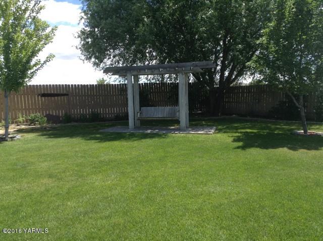 5407 Postma Road Yakima, WA 98901 - Photo 12 of 31 a view of a backyard with large trees and wooden fence