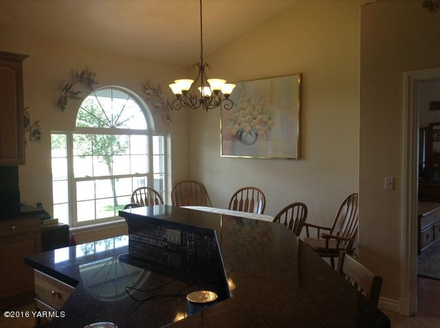 5407 Postma Road Yakima, WA 98901 - Photo 19 of 31 a view of a dining room with furniture a chandelier and wooden floor