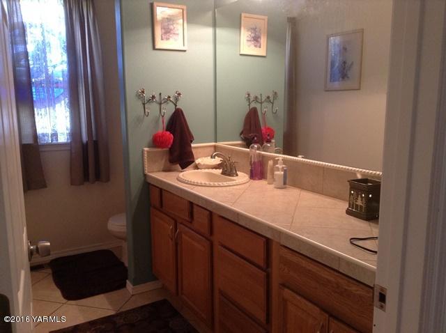 5407 Postma Road Yakima, WA 98901 - Photo 29 of 31 a bathroom with a sink and a mirror