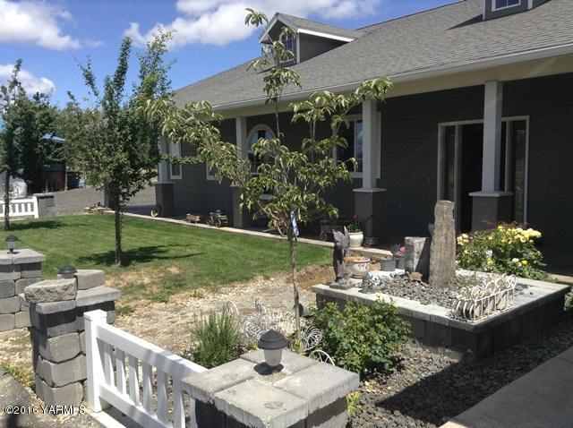5407 Postma Road Yakima, WA 98901 - Photo 5 of 31 a view of a patio with table and chairs potted plants and floor to ceiling window