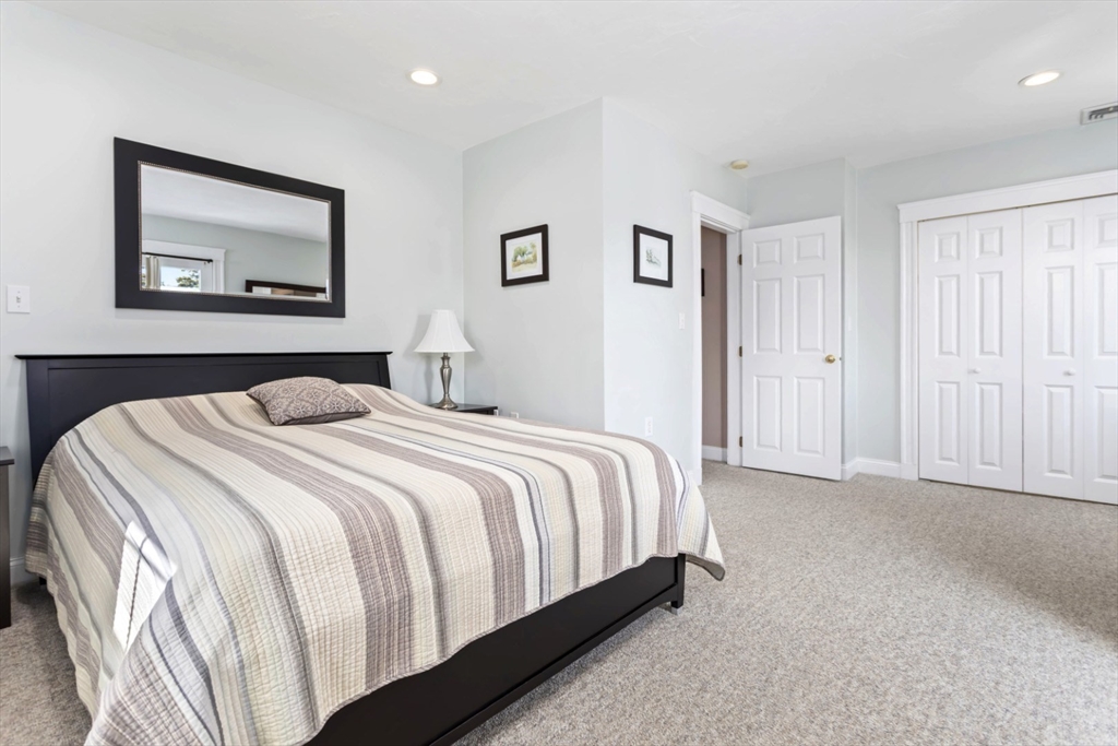 80 Squanto Road Quincy, MA 02169 - Photo 18 of 42 a bedroom with a bed and wall painting