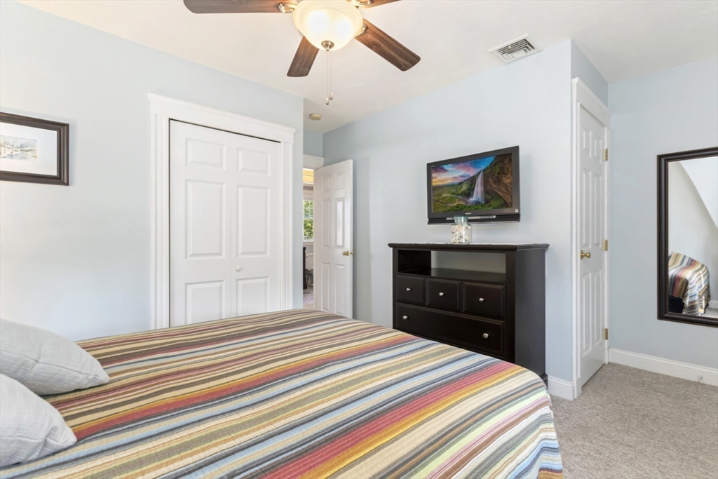 80 Squanto Road Quincy, MA 02169 - Photo 25 of 42 a bedroom with a bed and a chandelier